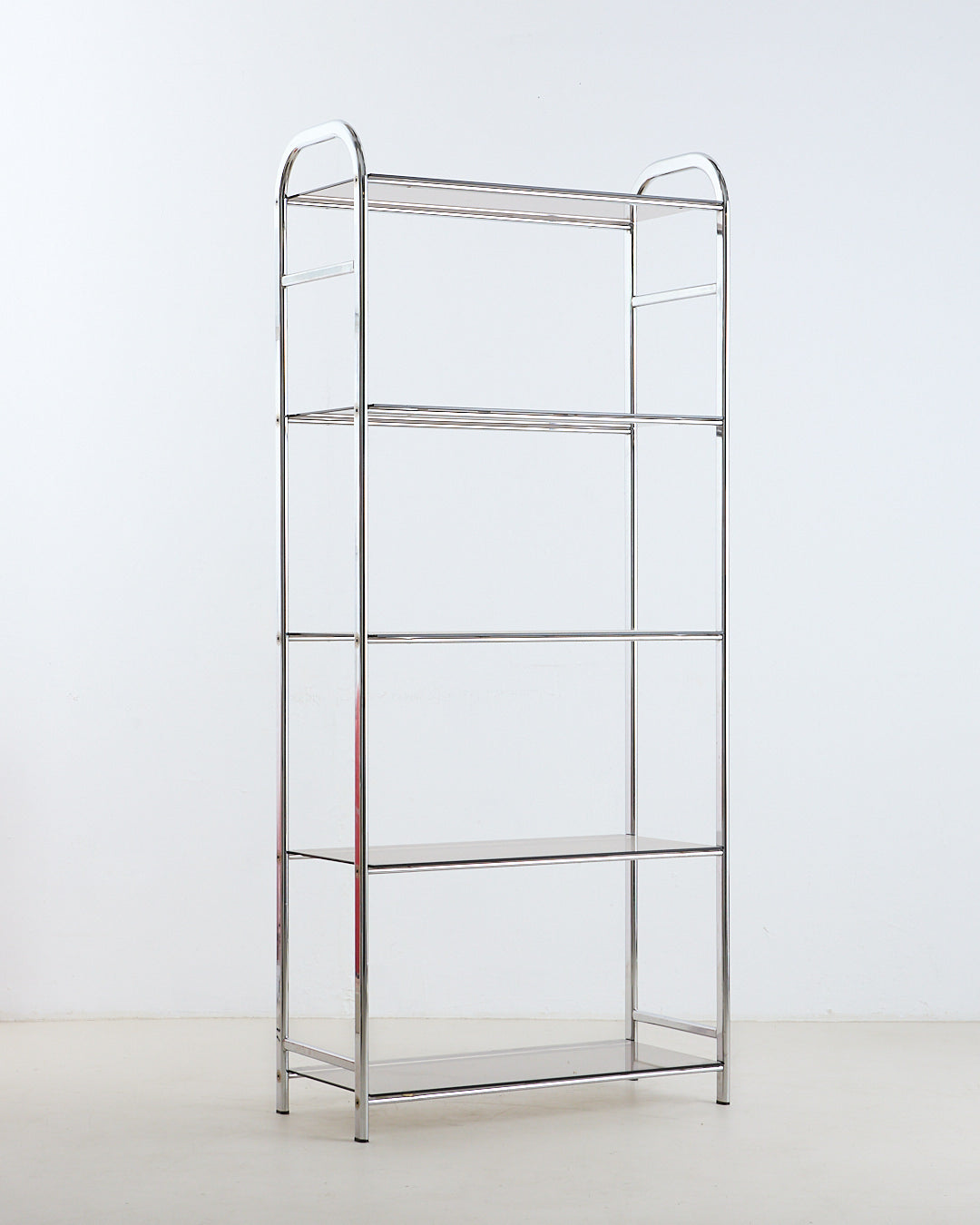 Vintage tubular steel bookshelf with smoked glass shelves