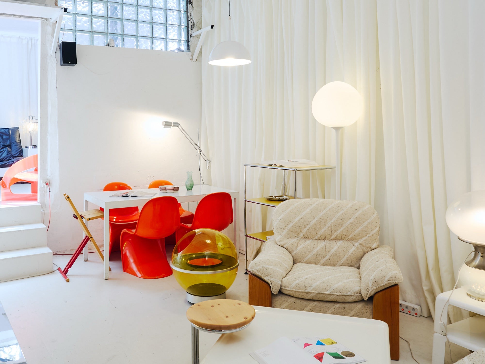 Curtain room with orange chairs at Kioskio